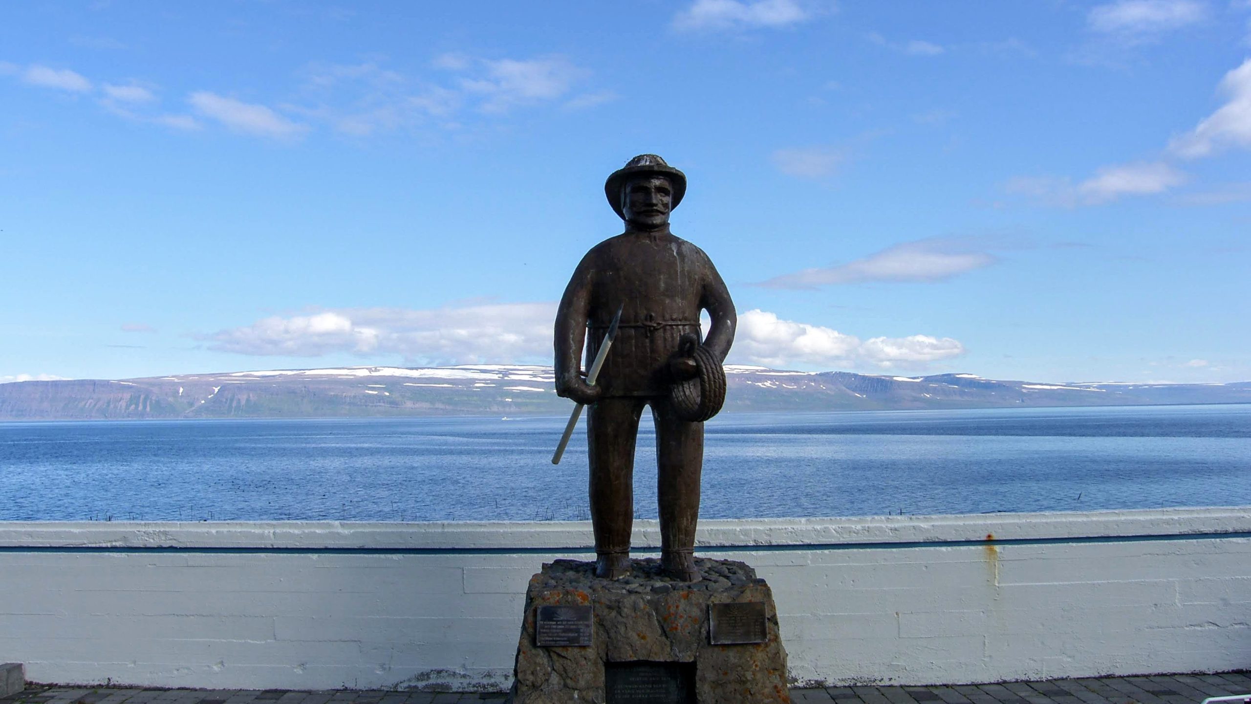 Statue Of Fishermen At Graveyard In Hnifsdalur Valley In The Westfjords